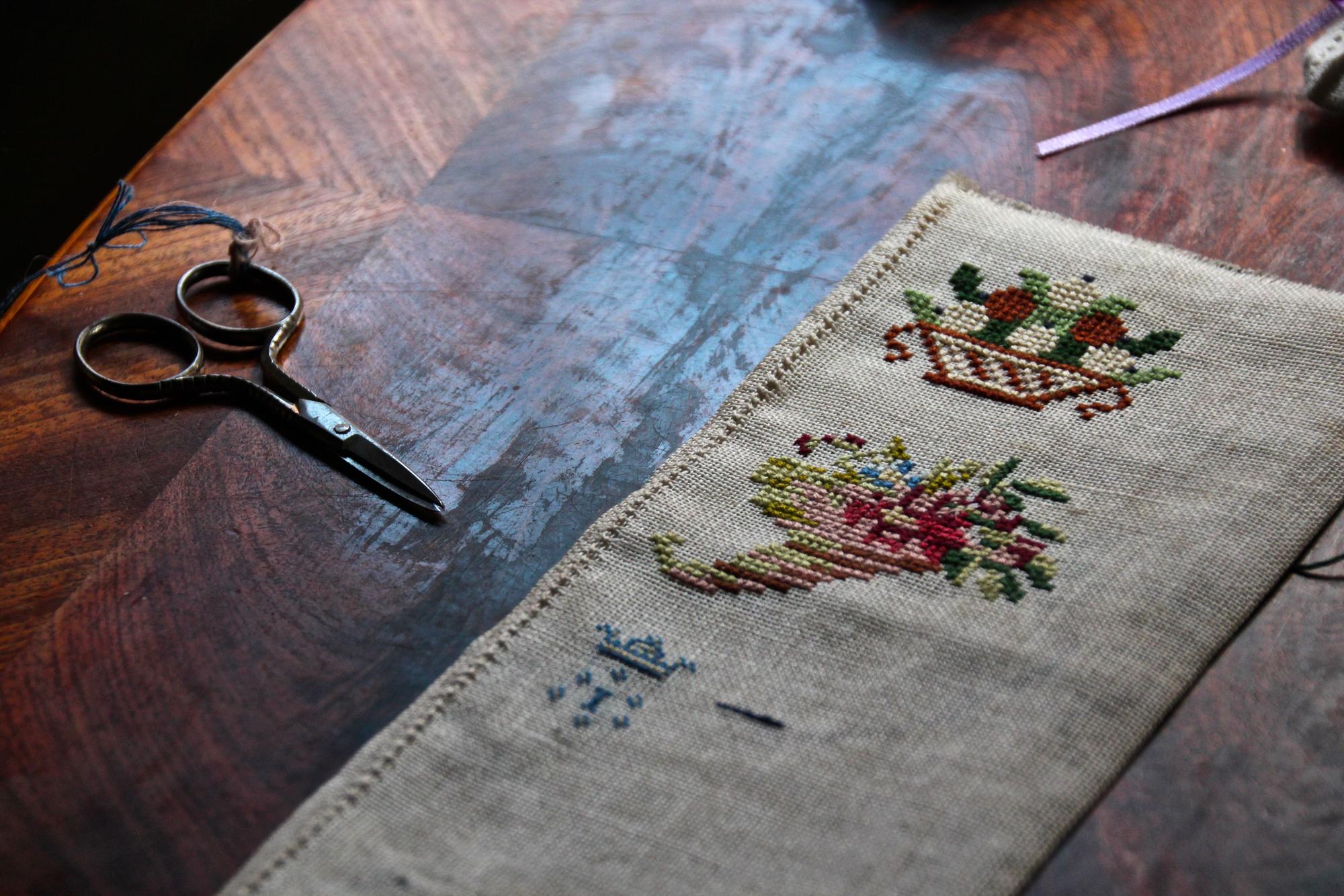 Large embroidered table runner on wooden table